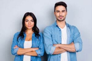 He vs she portrait of caucasion hispanic couple in jeans shirt